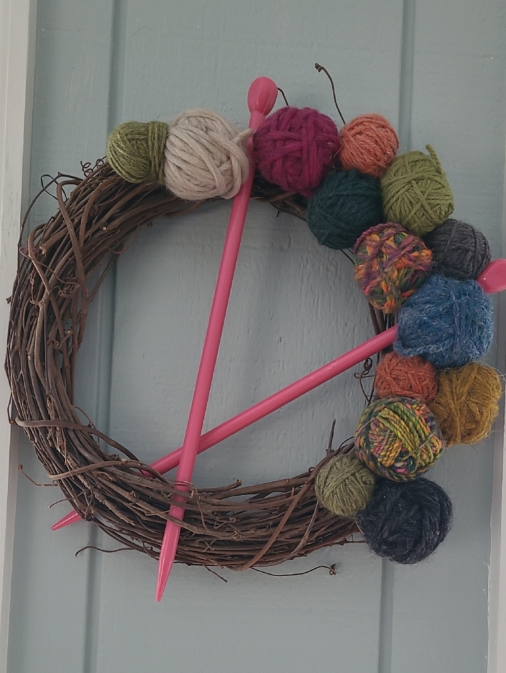 Grape Vine Wreath Adorned With Yarn Balls And A Pair Of Knitting Needles 10 mm